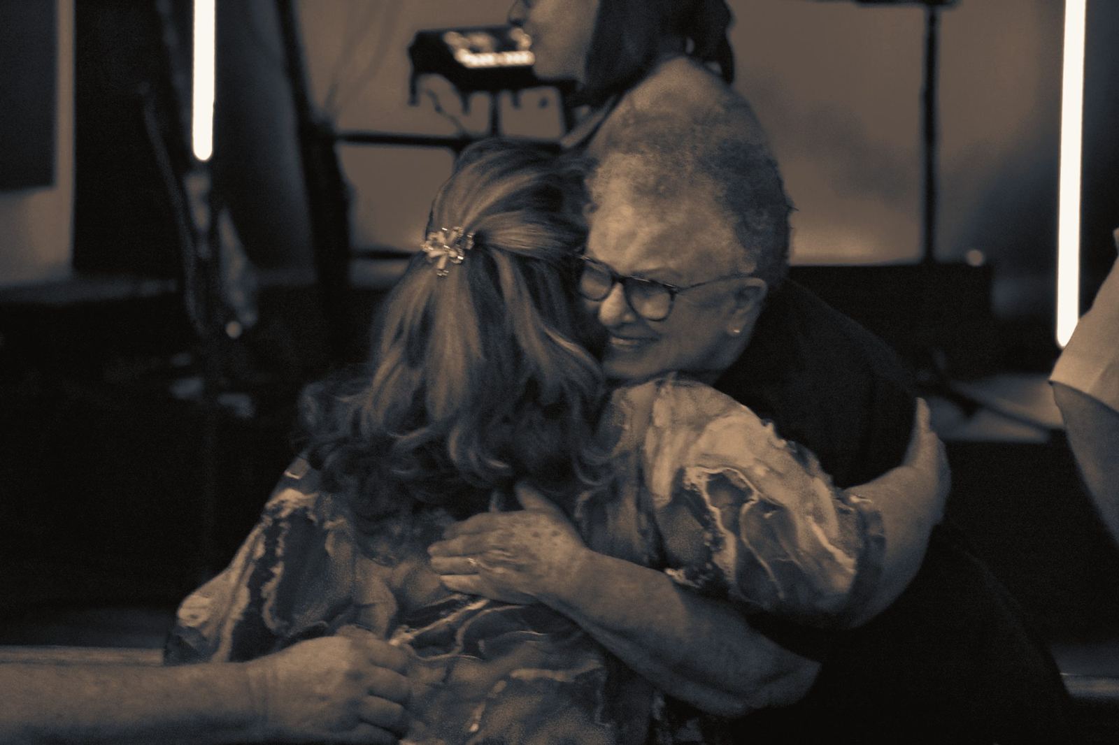 Two church members sharing a warm hug after a service